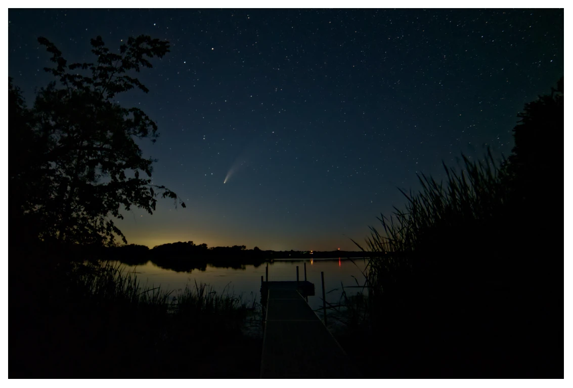A nighttime long exposure of Comet Neowise over a dock pointing into South Bay, Lake Ontario.