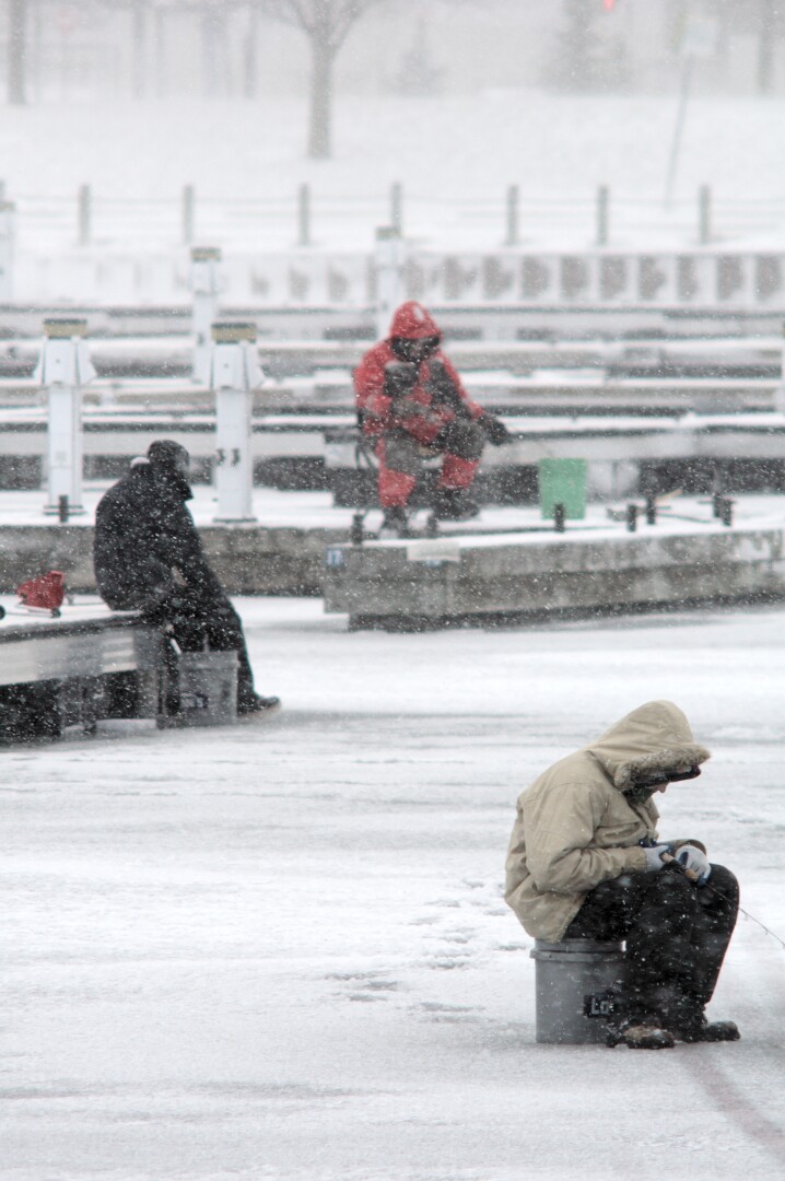 Three ice fishermen at the Barrie marina looking miserable in the snow