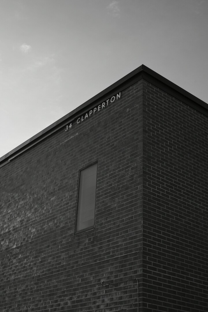 Black and white shot of the corner of the brick building at 34 Clapperton St in Barrie Ontario